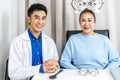 Young asian man ophthalmologist doing eye test senior woman in ophthalmological clinics, doing eye test checking on optical Royalty Free Stock Photo