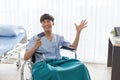 Young Asian man patient showing mock up credit card at the hospital