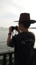 Young Asian Man Photoshooting at the Seaside during sunset Royalty Free Stock Photo