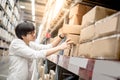 Young Asian man picking paper boxes in warehouse Royalty Free Stock Photo