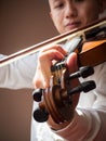 Young Asian man play violin. Classical music instrument. Art and music portrait background. Warm color tone. Royalty Free Stock Photo