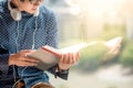 Young Asian man reading book in library Royalty Free Stock Photo