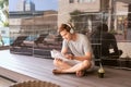 Young asian man reading book and listening to music by the pool Royalty Free Stock Photo