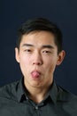 Young Asian man showing his tongue Royalty Free Stock Photo