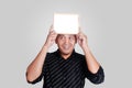 Young Asian Man Showing Small Whiteboard Covering His Head Royalty Free Stock Photo