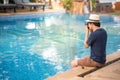 Young Asian man taking photo near of swimming pool Royalty Free Stock Photo