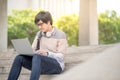 Young Asian man university student sitting on stair Royalty Free Stock Photo