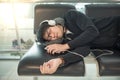 Young Asian man sleeping on bench in airport terminal Royalty Free Stock Photo