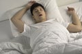 Young  Asian man sleeping and snoring loudly lying in the bed Royalty Free Stock Photo