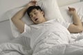 Young  Asian man sleeping and snoring loudly lying in the bed Royalty Free Stock Photo