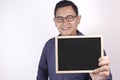 Young Asian Man Smiling and Presenting Empty Copy Space Blackboard Royalty Free Stock Photo
