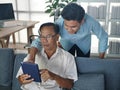 the young asian man spending good lifestyle time with older father on mobile technology together