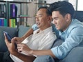 The young asian man spending good lifestyle time with older father on mobile technology together