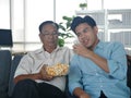 The young asian man spending good lifestyle time with older father on mobile technology together