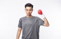 Young asian man in sport outfits exercising with dumbbells and looking to camera isolated on white background. Royalty Free Stock Photo