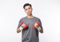 Young asian man in sport outfits exercising with dumbbells and looking to camera isolated on white background. Royalty Free Stock Photo
