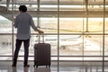 Young man with suitcase luggage in airport terminal Royalty Free Stock Photo