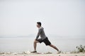 Young asian man stretching legs outdoors Royalty Free Stock Photo