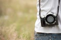 Young asian man taking photo outdoors with DSLR digital camera. Young cheerful female tourist having fun in coffee shop. Royalty Free Stock Photo