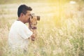 Young asian man taking photo outdoors with DSLR digital camera Royalty Free Stock Photo