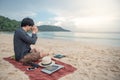 Young Asian taking photo on the beach