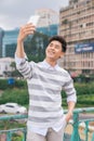 Young Asian man taking selfie on the background of city Royalty Free Stock Photo