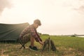 Young Asian man tourist making bonfire and set camping tent Royalty Free Stock Photo