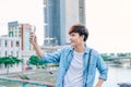 Young asian man tourist taking selfie photo using smartphone out Royalty Free Stock Photo