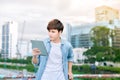 Young asian man tourist using digita; tablet outdoor in the city