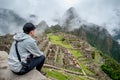 Young Asian man traveler looking at Machu Picchu