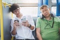 Young Asian man traveler sitting on a bus using smartphone for l