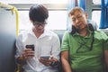 Young Asian man traveler sitting on a bus using smartphone for listening music and mature men sleeping with pillow, transport,