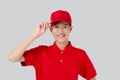 Young asian man in uniform and red cap standing and catch a hat with confident isolated white background.