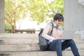 Young Asian man university student sitting on stair Royalty Free Stock Photo