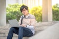 Young Asian man university student sitting on stair Royalty Free Stock Photo