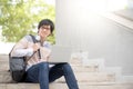 Young Asian man university student sitting on stair Royalty Free Stock Photo