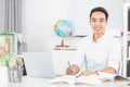 Young Asian man university student working with laptop computer.