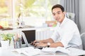 Young Asian man university student working with laptop computer. Royalty Free Stock Photo