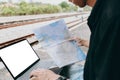 Young asian man using laptop and check map for working and search location for travel at train station. Freelance work and travel Royalty Free Stock Photo