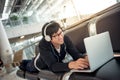 Young man listening to music waiting in airport terminal Royalty Free Stock Photo