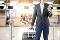 Young asian man using smartphone in airport terminal Royalty Free Stock Photo