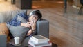 Young Asian man using smartphone relaxing on sofa Royalty Free Stock Photo