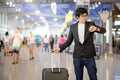 Young asian man waiting for the flight in airport Royalty Free Stock Photo