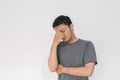 Young Asian man wear grey shirt with thinking and looking idea gesture