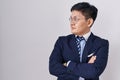 Young asian man wearing business suit and tie looking to the side with arms crossed convinced and confident Royalty Free Stock Photo