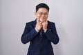 Young asian man wearing business suit and tie smiling with open mouth, fingers pointing and forcing cheerful smile Royalty Free Stock Photo
