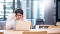 Asian man listening to music using laptop computer Royalty Free Stock Photo