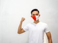 Young asian man wearing red and white mask, he was clenched his hand. Isolated on white background Royalty Free Stock Photo