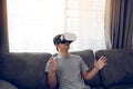 Young asian man wearing virtual reality glasses at living room for admiring virtual reality Royalty Free Stock Photo