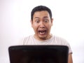 Young Man Screaming, Shocked Expression Looking at Laptop Royalty Free Stock Photo